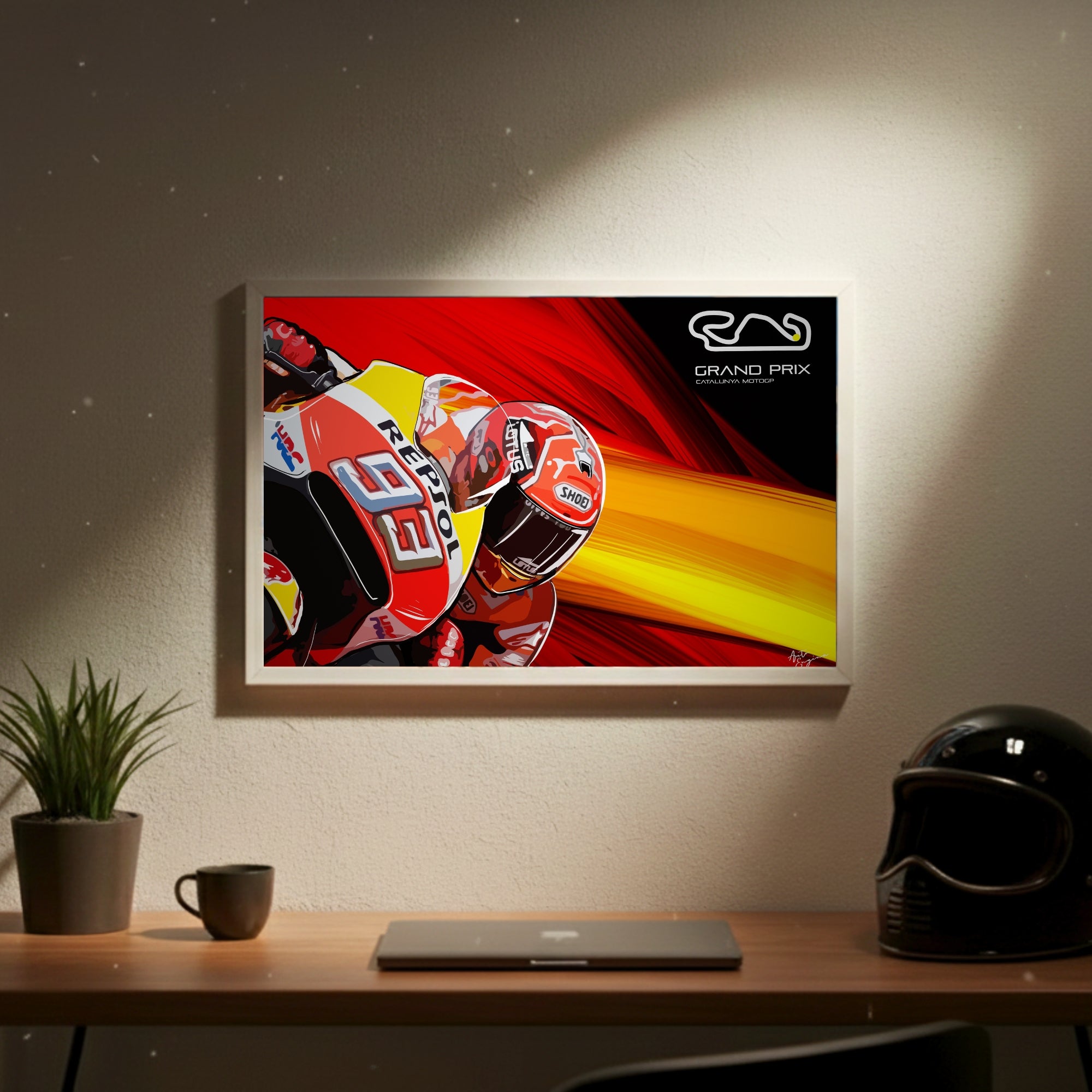 Framed artwork of a motorcycle racer on a wall above a desk with a helmet and mug.